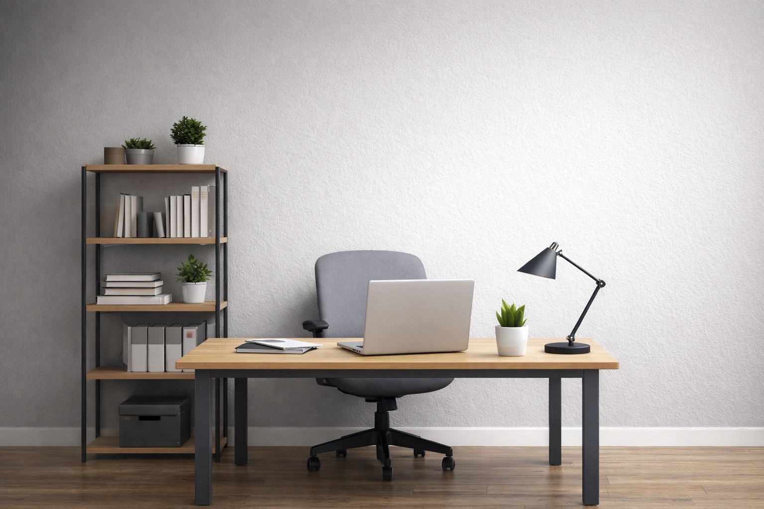 A minimalist office with a wooden desk, gray chair, laptop, desk lamp, a small plant, and a bookshelf holding books and potted plants, set against a plain light-colored wall and wooden floor.